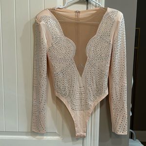 Never before worn rhinestone bodysuit. It was too big for me.